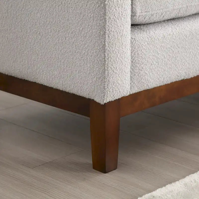 Elegante panca imbottita, con gambe in legno